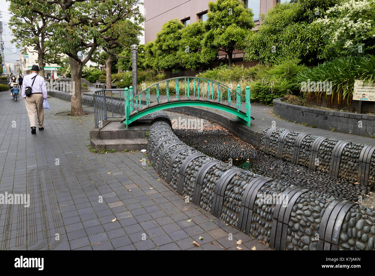 Tokyo,Japan, May 15, 2017: Rain water drainage in the city of Tokyo with a bridge for pedestrians Stock Photo