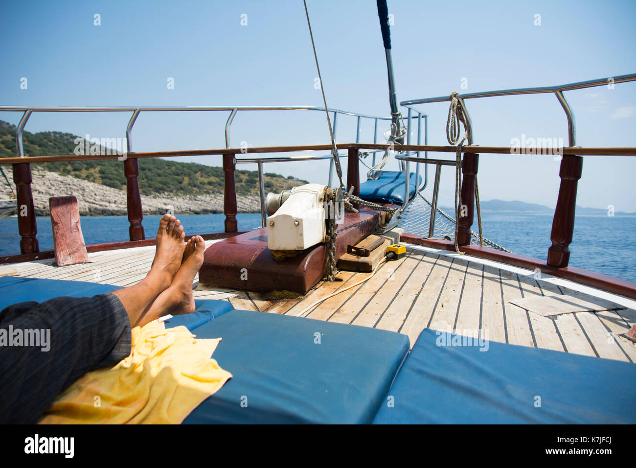 A relaxing tourist feets in a boat on the Egean sea in Kas, Turkey Stock Photo