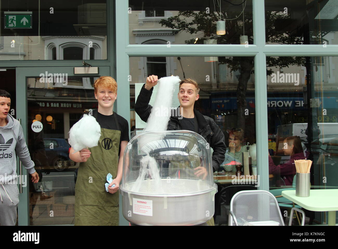 A street vendor makes a order of candy floss at a street fair Stock