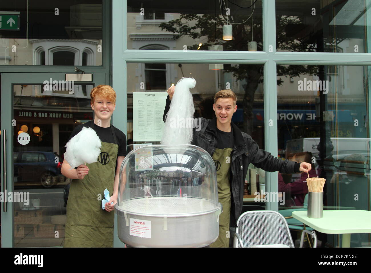 A street vendor makes a order of candy floss at a street fair Stock