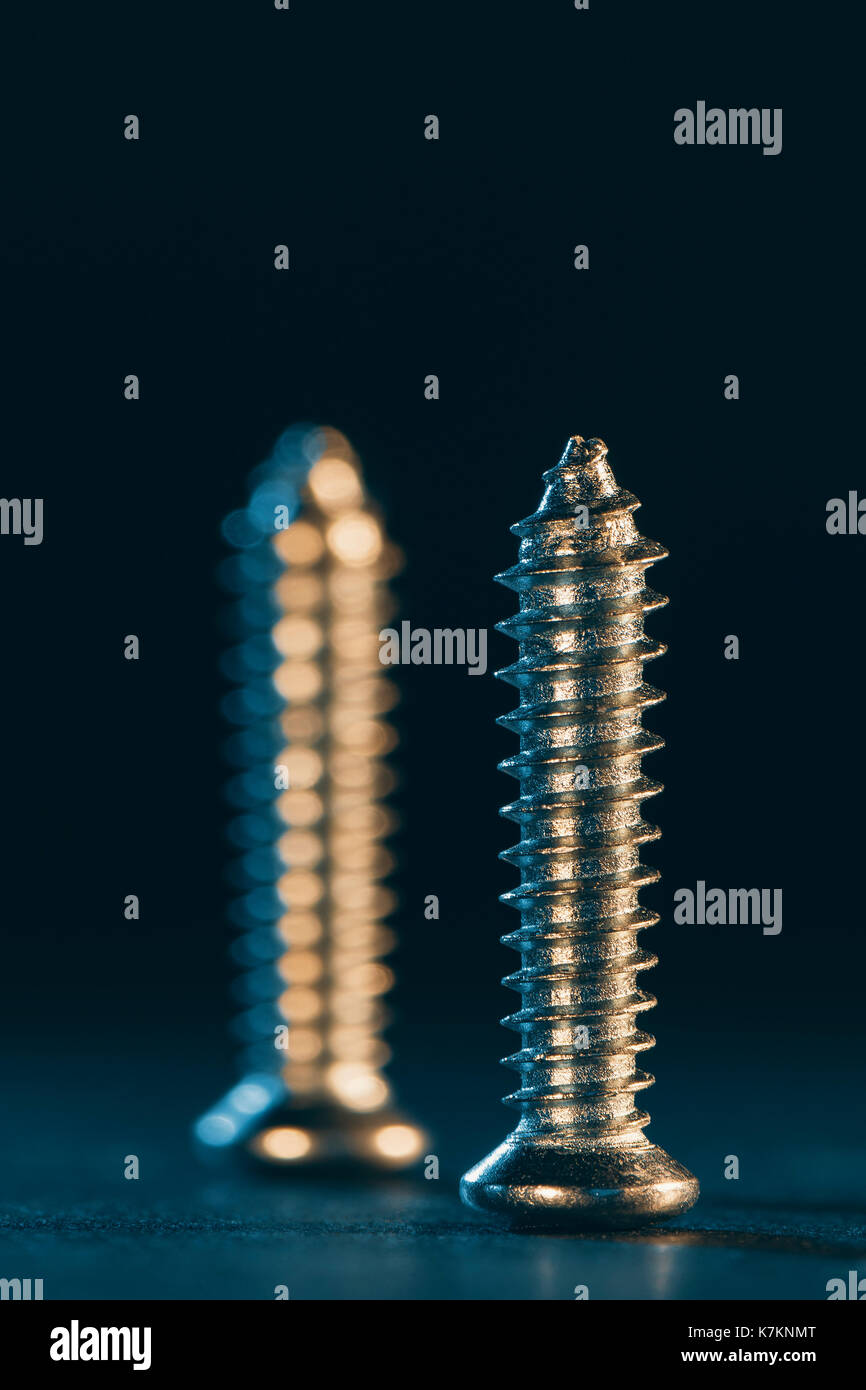 Two screw on blue background Stock Photo