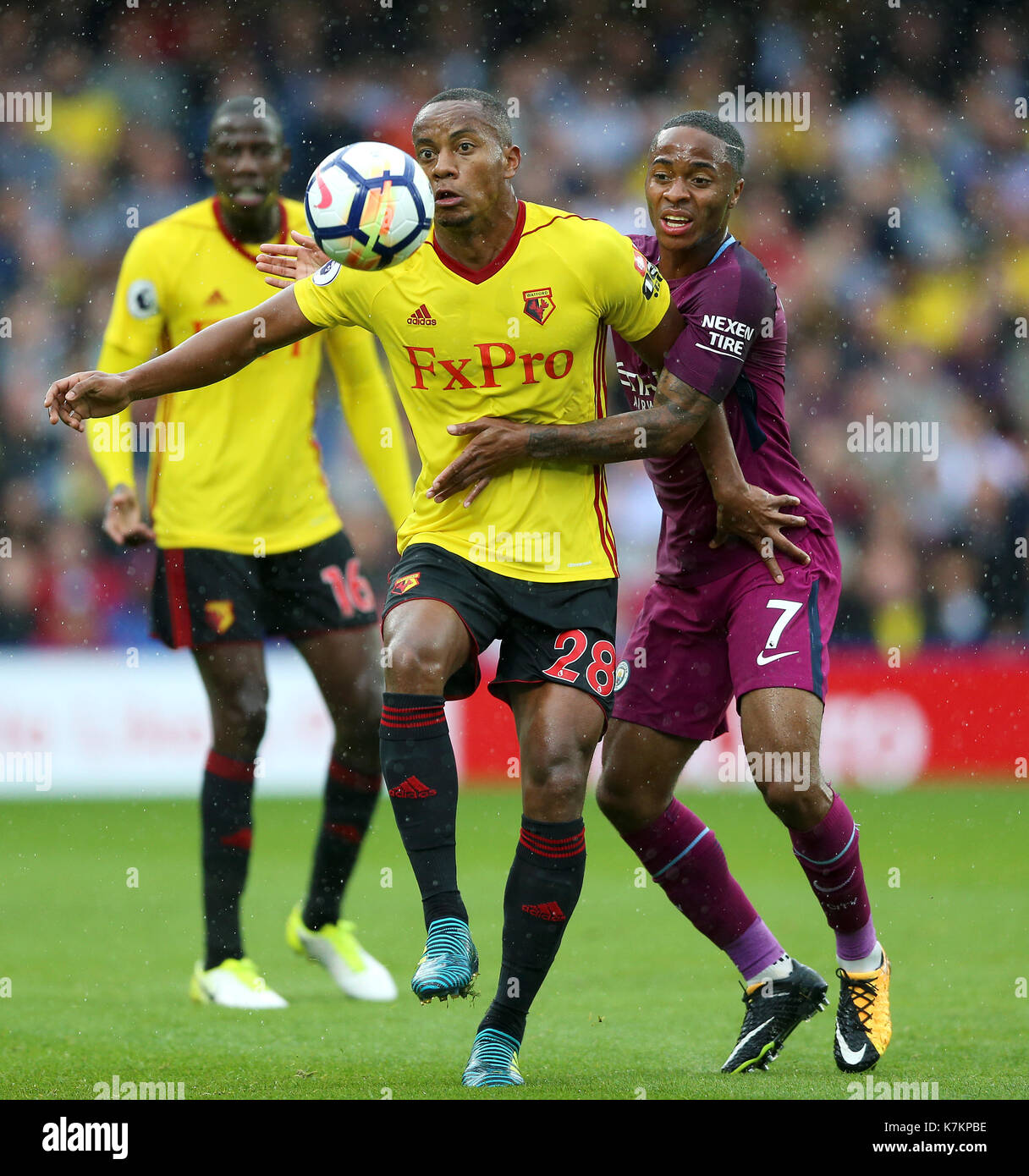 Watford's Andre Carrillo (left) and Manchester City's Raheem Sterling in action during the Premier League match at Vicarage Road, Watford. Stock Photo