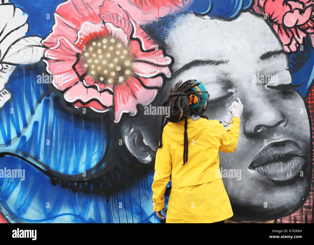 Street artist Kathrina Rupit aka Kinmx works on the 'Peace and Love Cube' during the BlueFire street fest in Smithfield, Dublin. Stock Photo