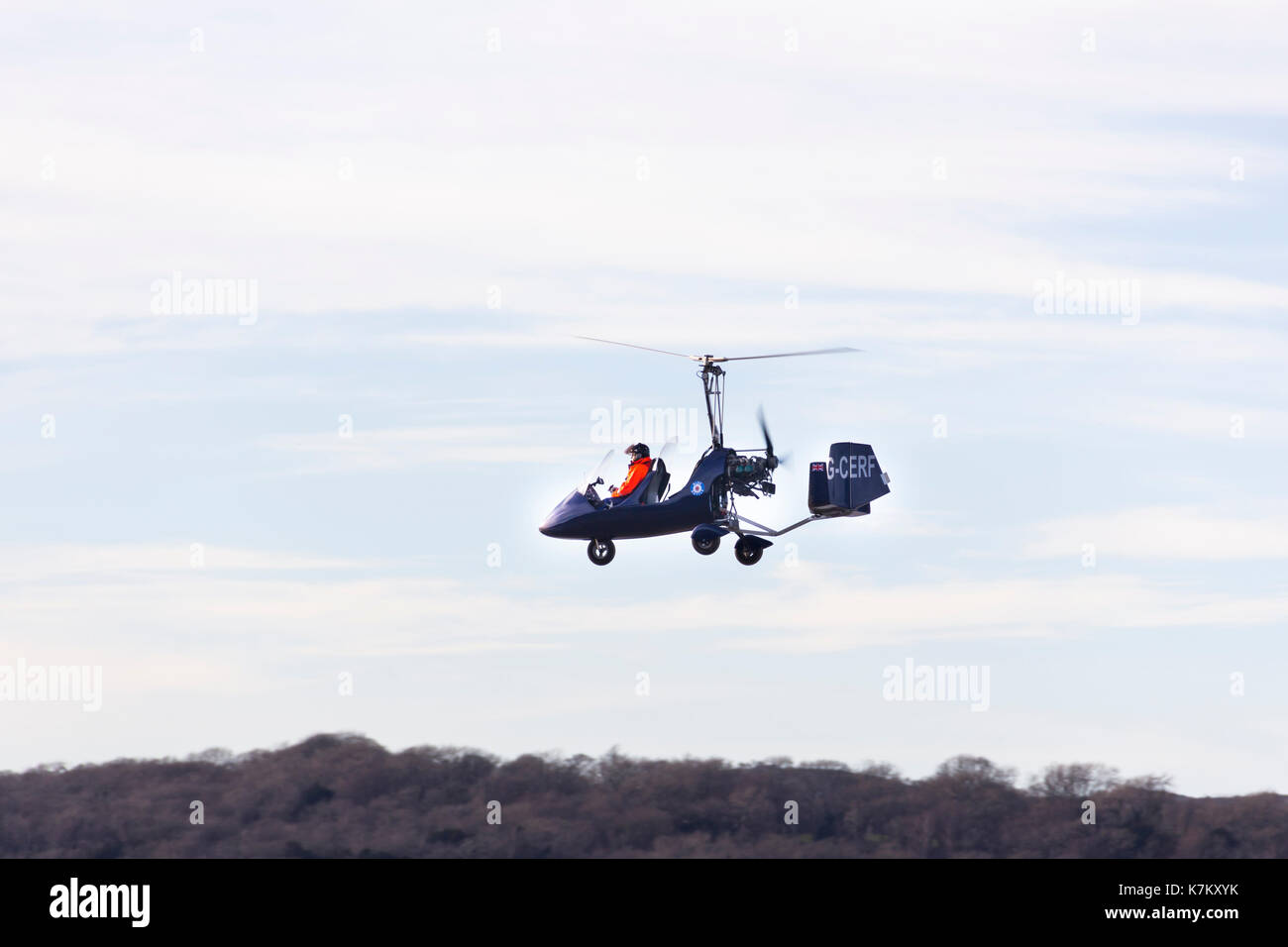 A Rotorsport UK MT-03 gyrocopter flying low over the River Kent estuary an Arnside, Cumbria. The MT-03 is version of the German built AutoGyro MT-03,  Stock Photo