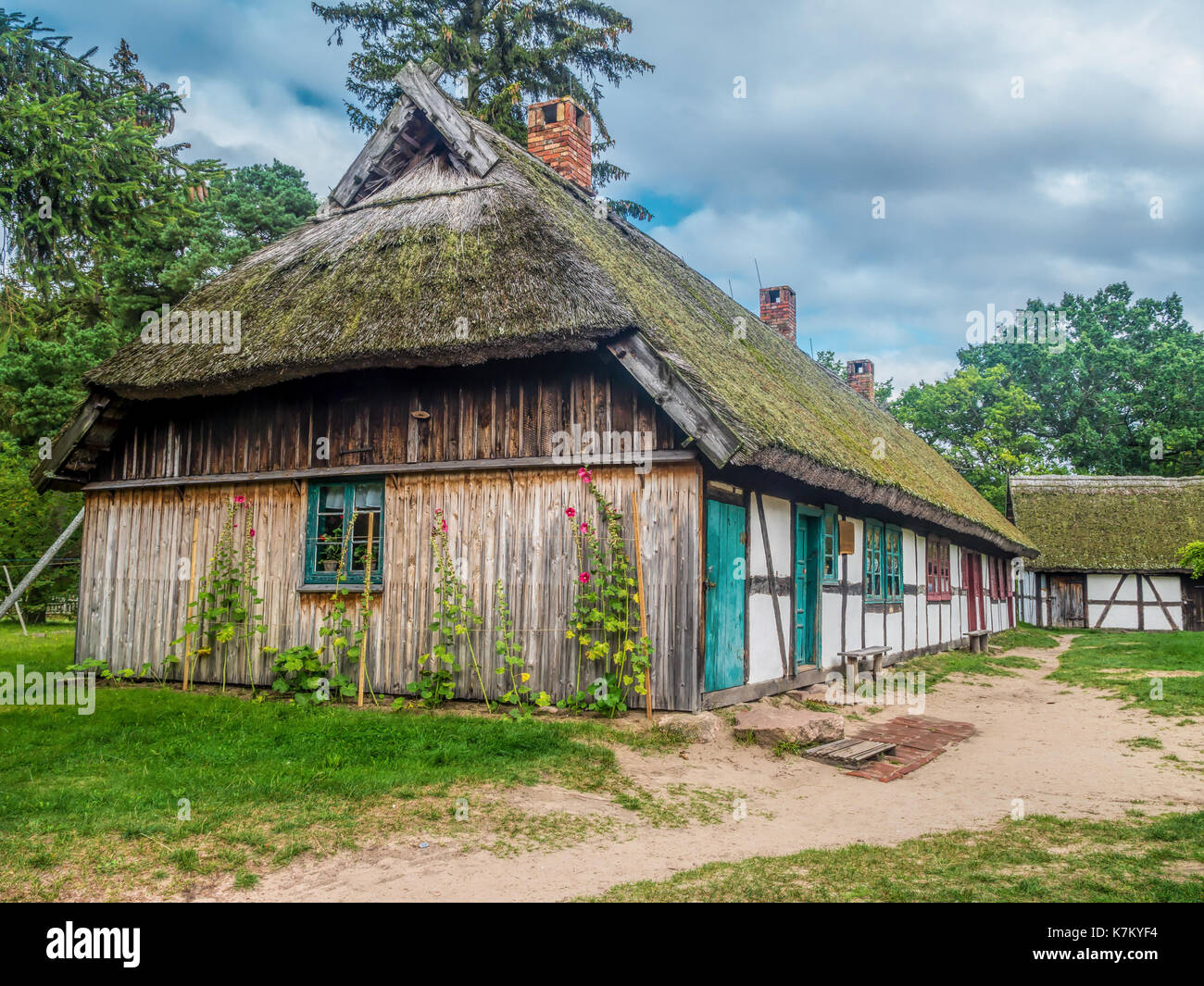 Old wooden farmstead with typical timber framing, part of heritage park in Kluki, Poland Stock Photo