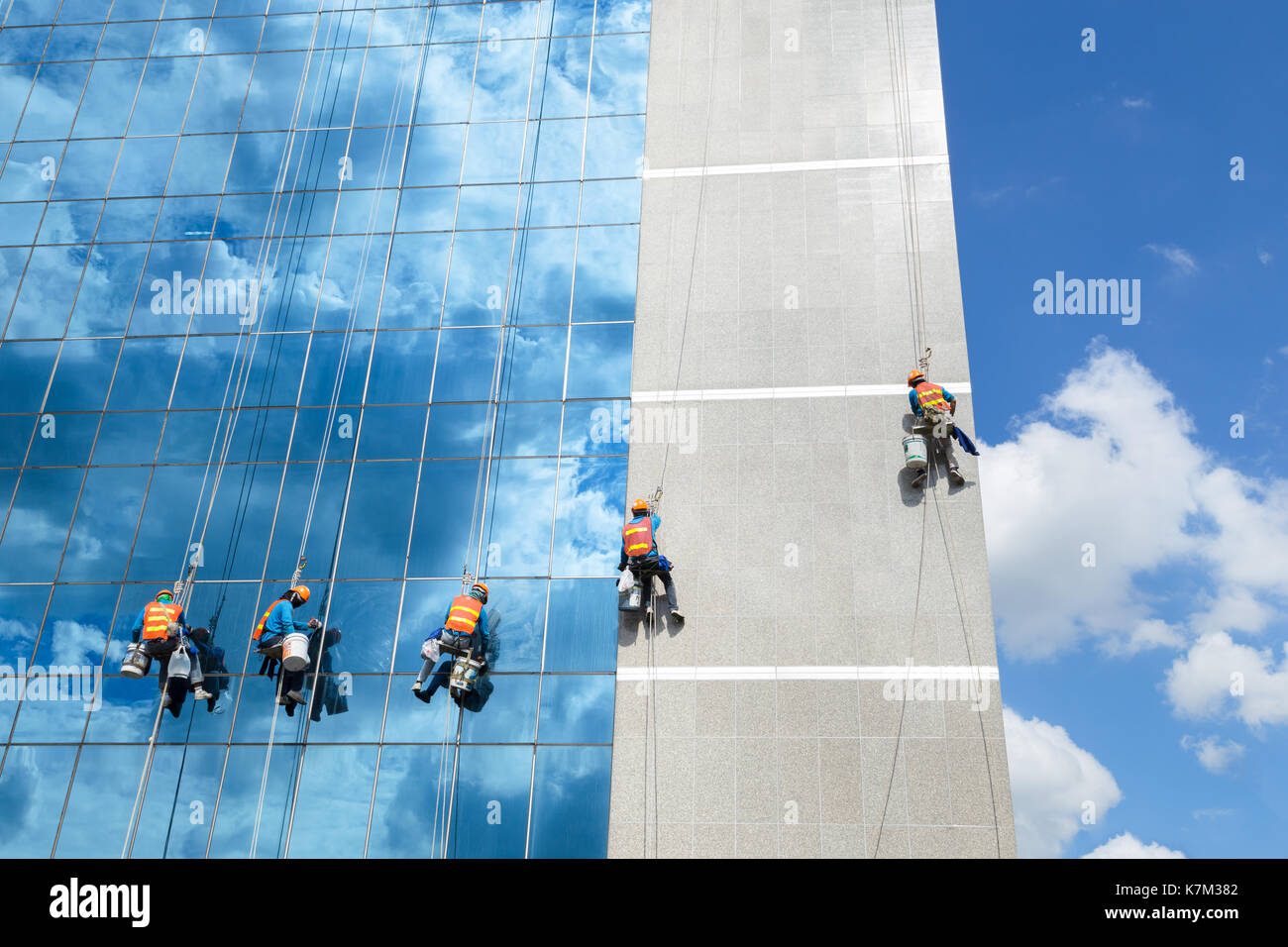 Workers cleaning windows mirror service on high rise building Stock Photo Alamy