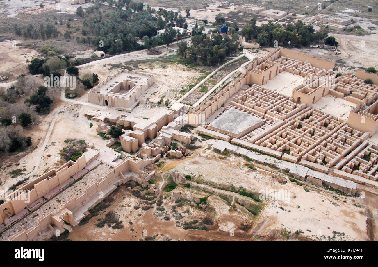 Ruins of the South palace of ancient Babylon, Iraq on the right. Ninmah temple and the original Ishtar gate on the left. Stock Photo