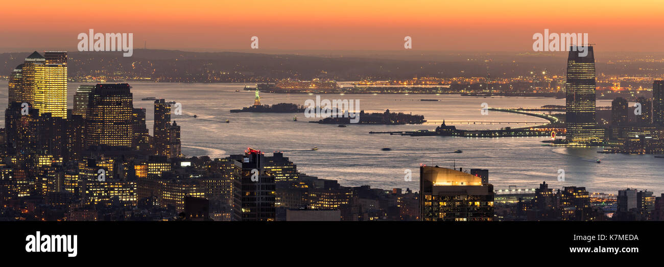 Panoramic aerial view of New York Harbor at sunset, with Ellis Island, Liberty Island. New York City Stock Photo