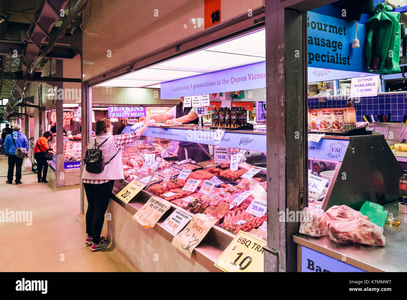Australia Melbourne Queen Victoria Market, buying meat from a grocer