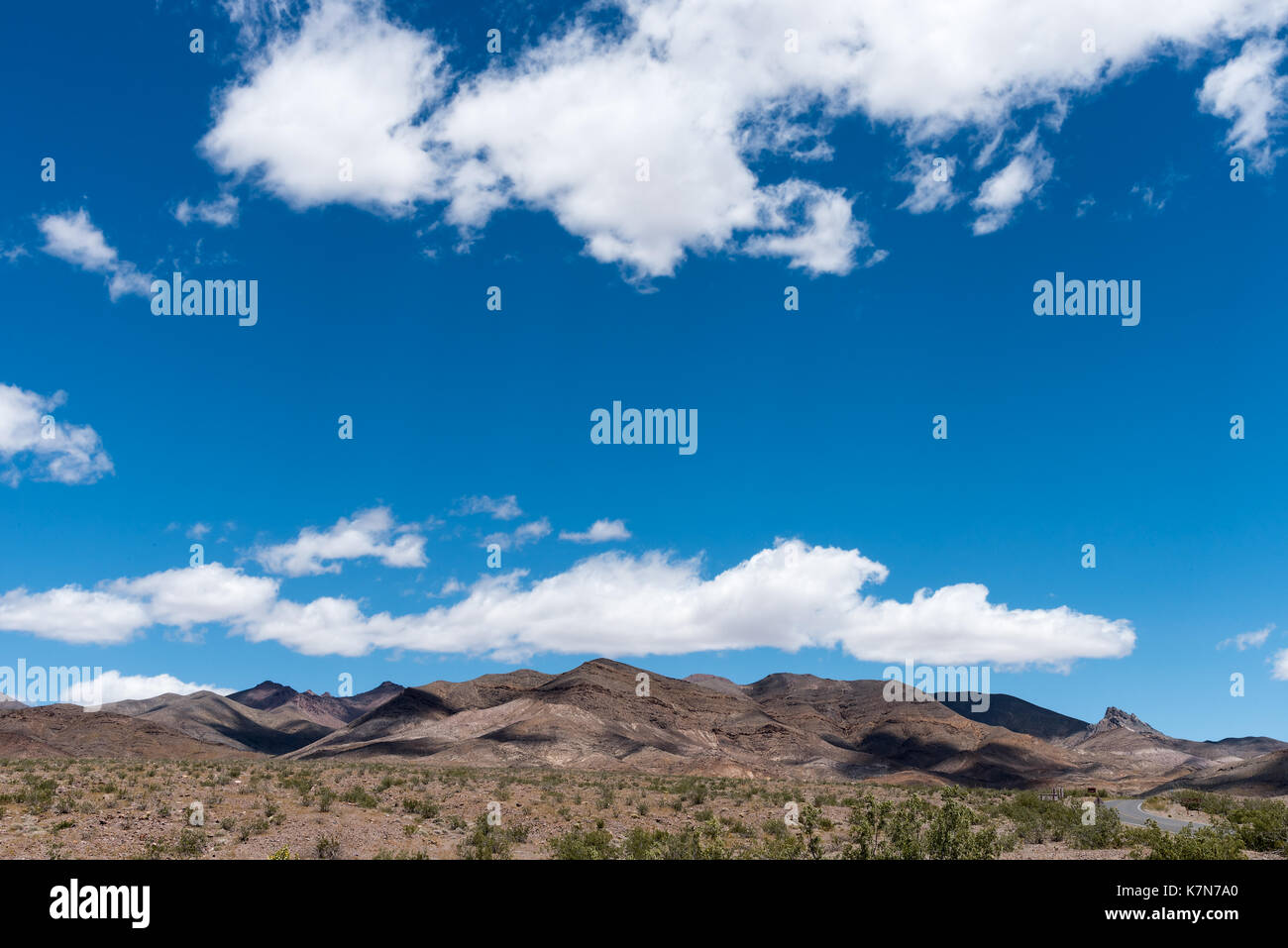 Desert Hills Under Blue Cloudy Sky Stock Photo - Alamy