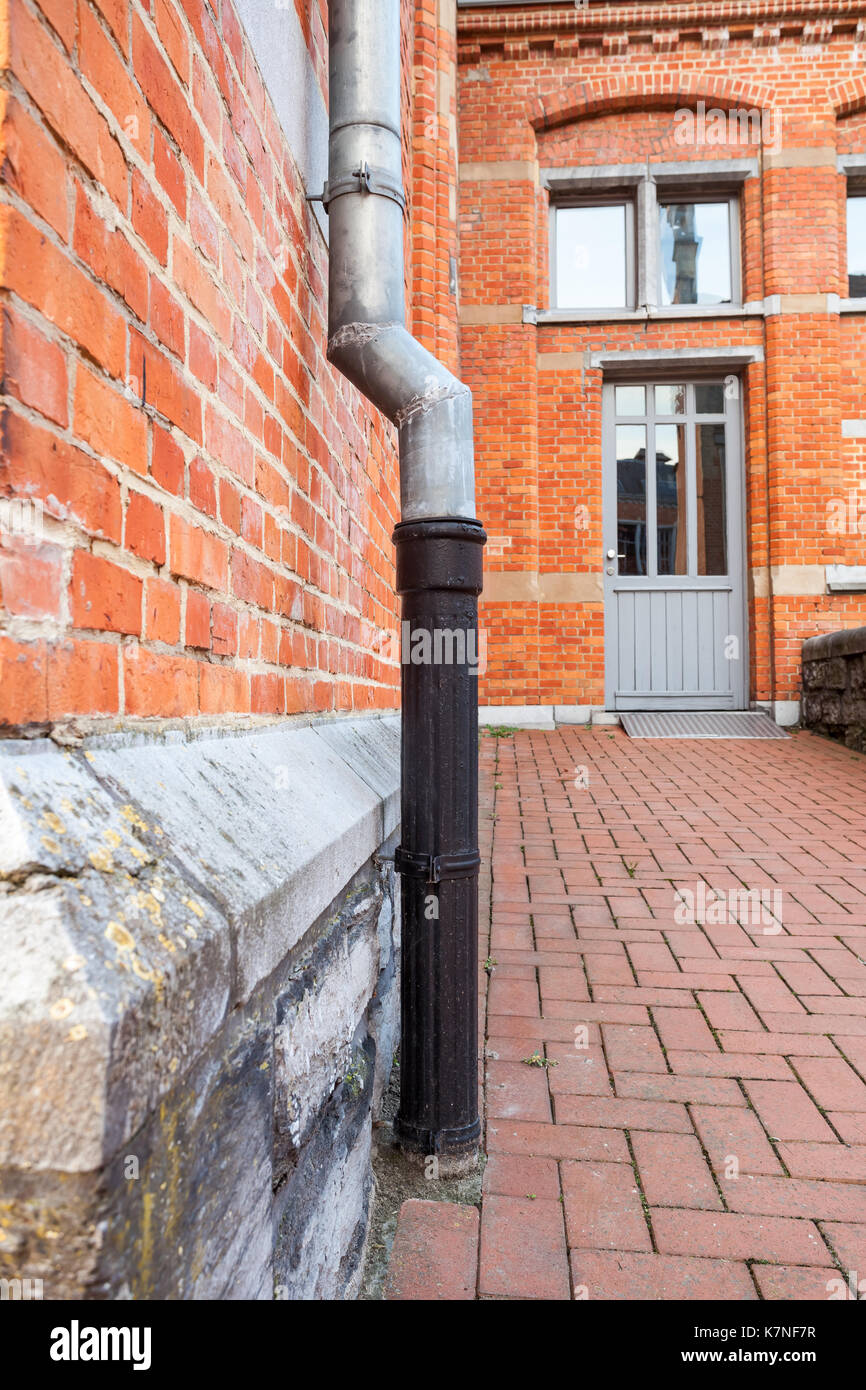 an rain drain pipe on an wall Stock Photo