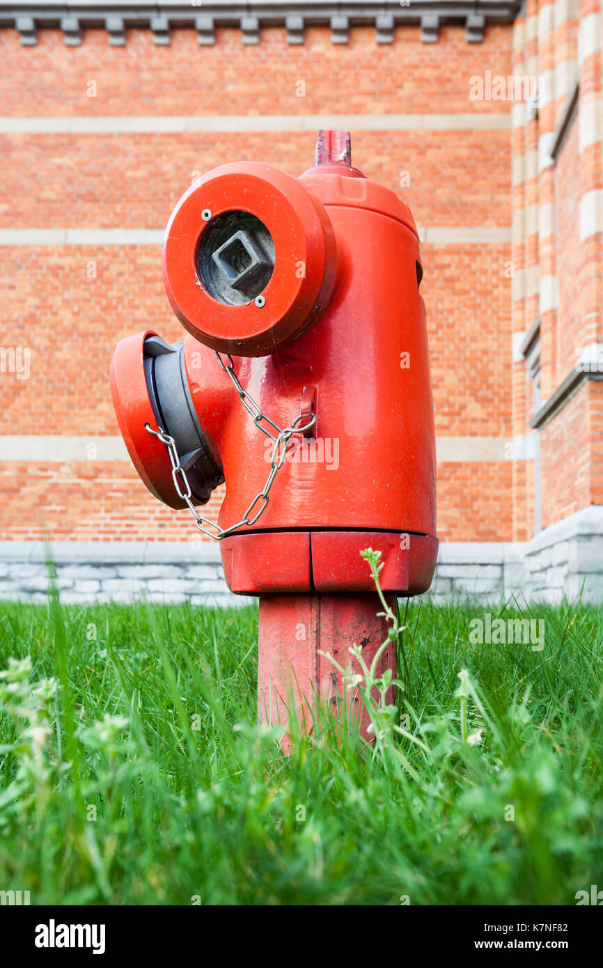 In the park in the grass is this old hydrant Stock Photo