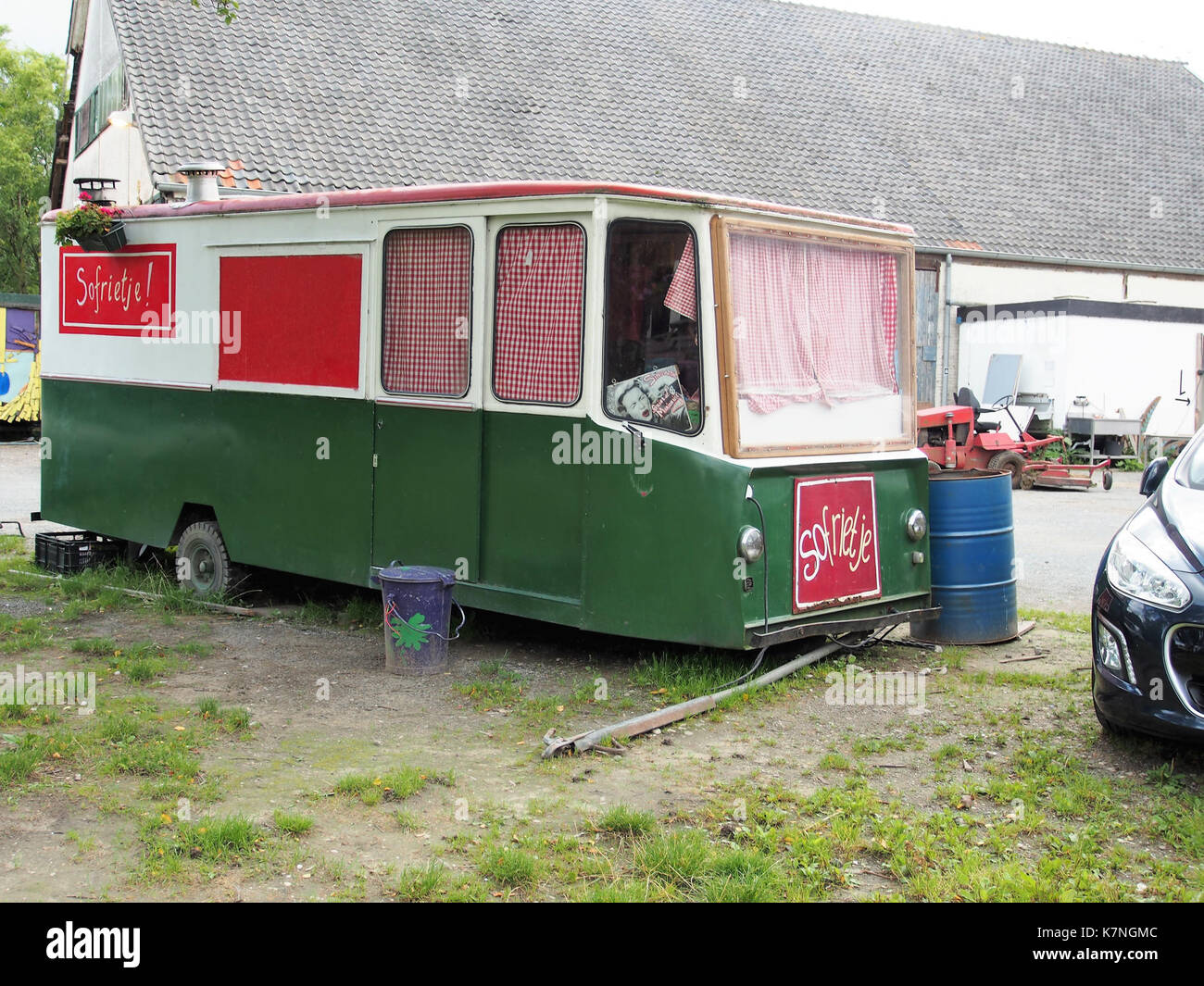 The image titled 'Ruigoord foto15' likely depicts a view of Ruigoord, a small artist village in the Netherlands known for its creative and alternative community atmosphere. It is renowned for its vibrant cultural activities and its integration of art and nature. Stock Photo