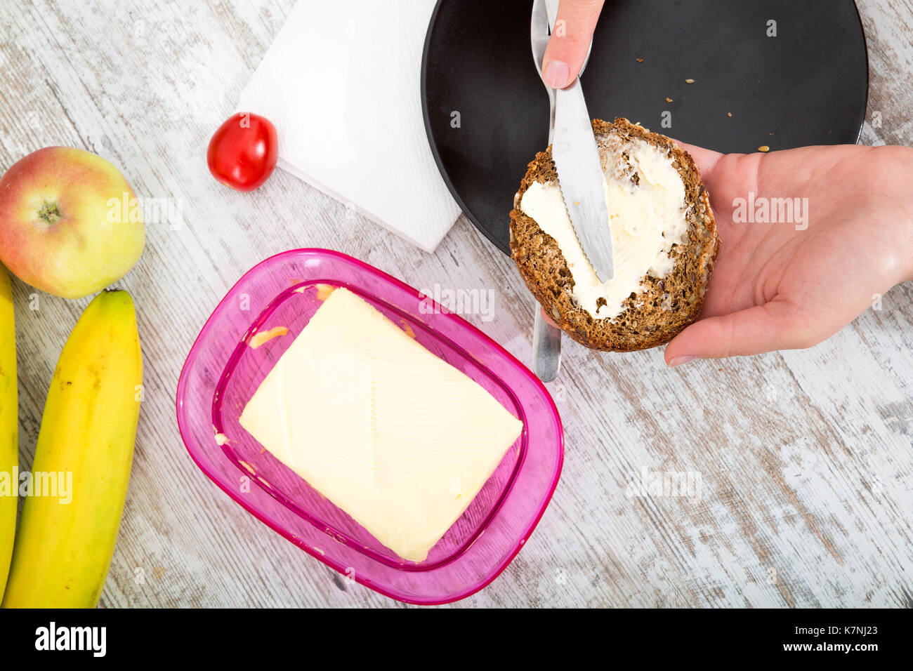 A woman having a breakfast at a table. Stock Photo