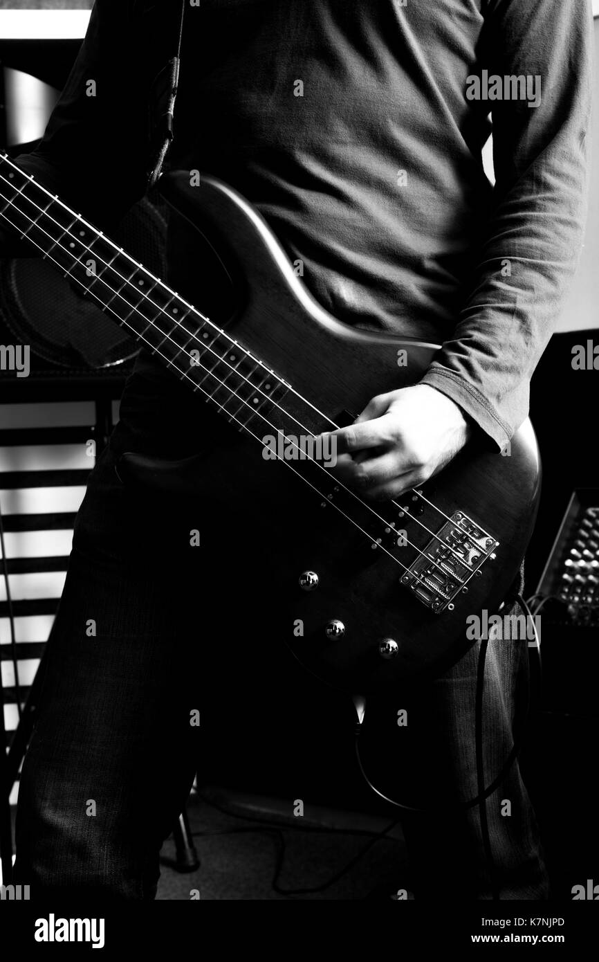 Black and white photo of a classic Rock musician playing bass. Stock Photo