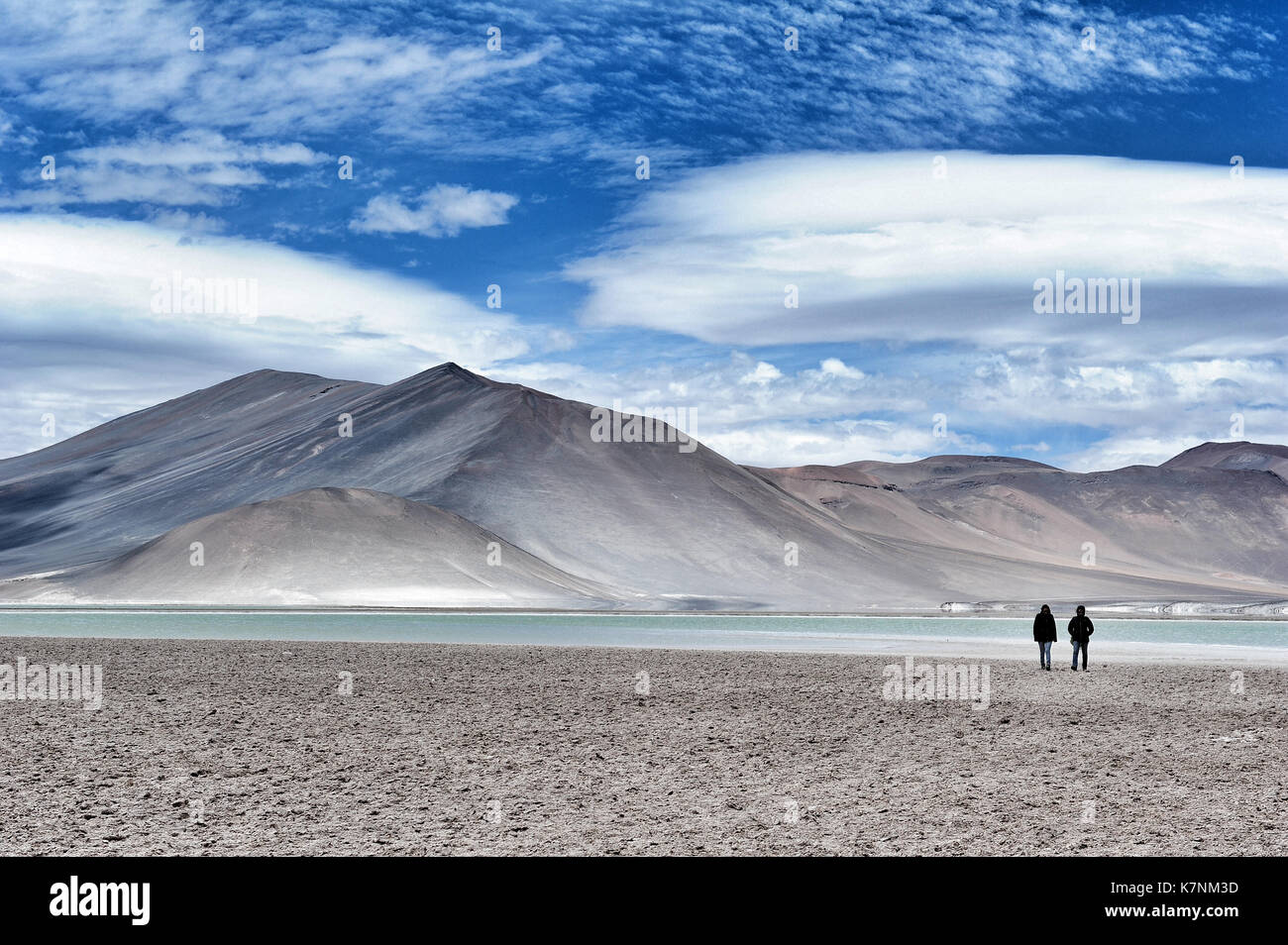 Two people admiring the view at Salar de Aguas Calientes, aka as Salar de Talar, Chile Stock Photo