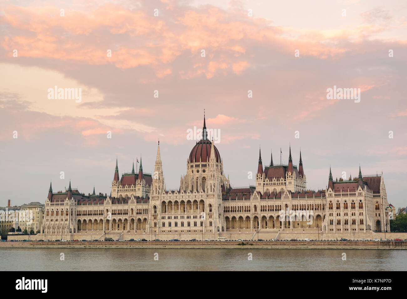 Image of the Hungarian Parliament in Budapest at sunset with the Danube in the foreground. Stock Photo