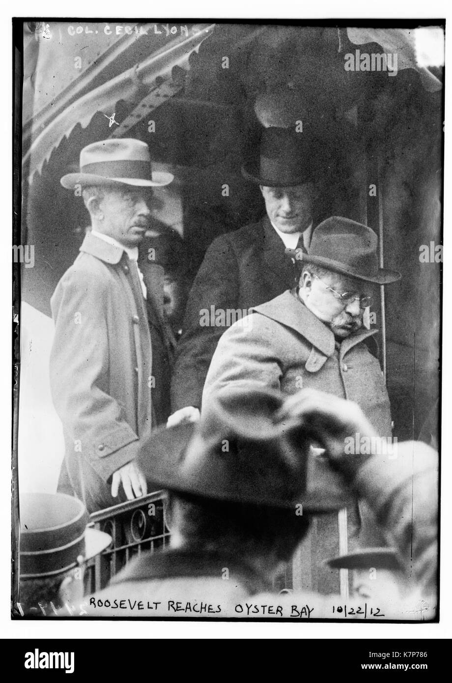 Photo shows President Teddy Roosevelt getting off a train at Oyster Bay, Long Island, following an assassination attempt by John F. Schrank. Col. Cecil Lyons is behind him on the train. 10/22/12. Stock Photo