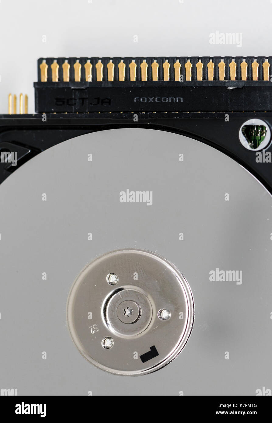 Close-up of an opened computer hard drive disk with the Foxconn company logo imprinted on the case. Stock Photo