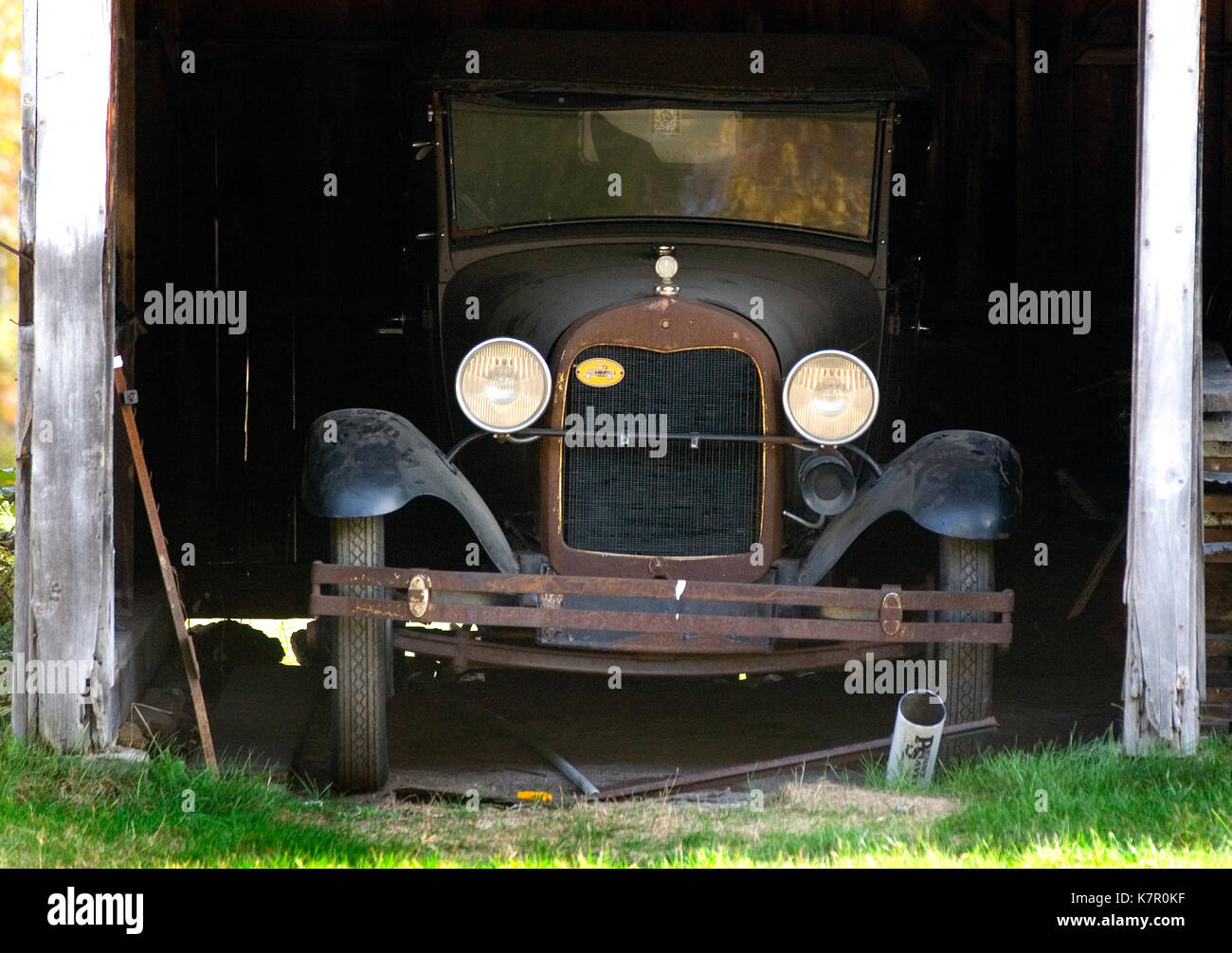 A vintage automobile in a barn along US Route 3 in Campton, New Hampshire. Stock Photo