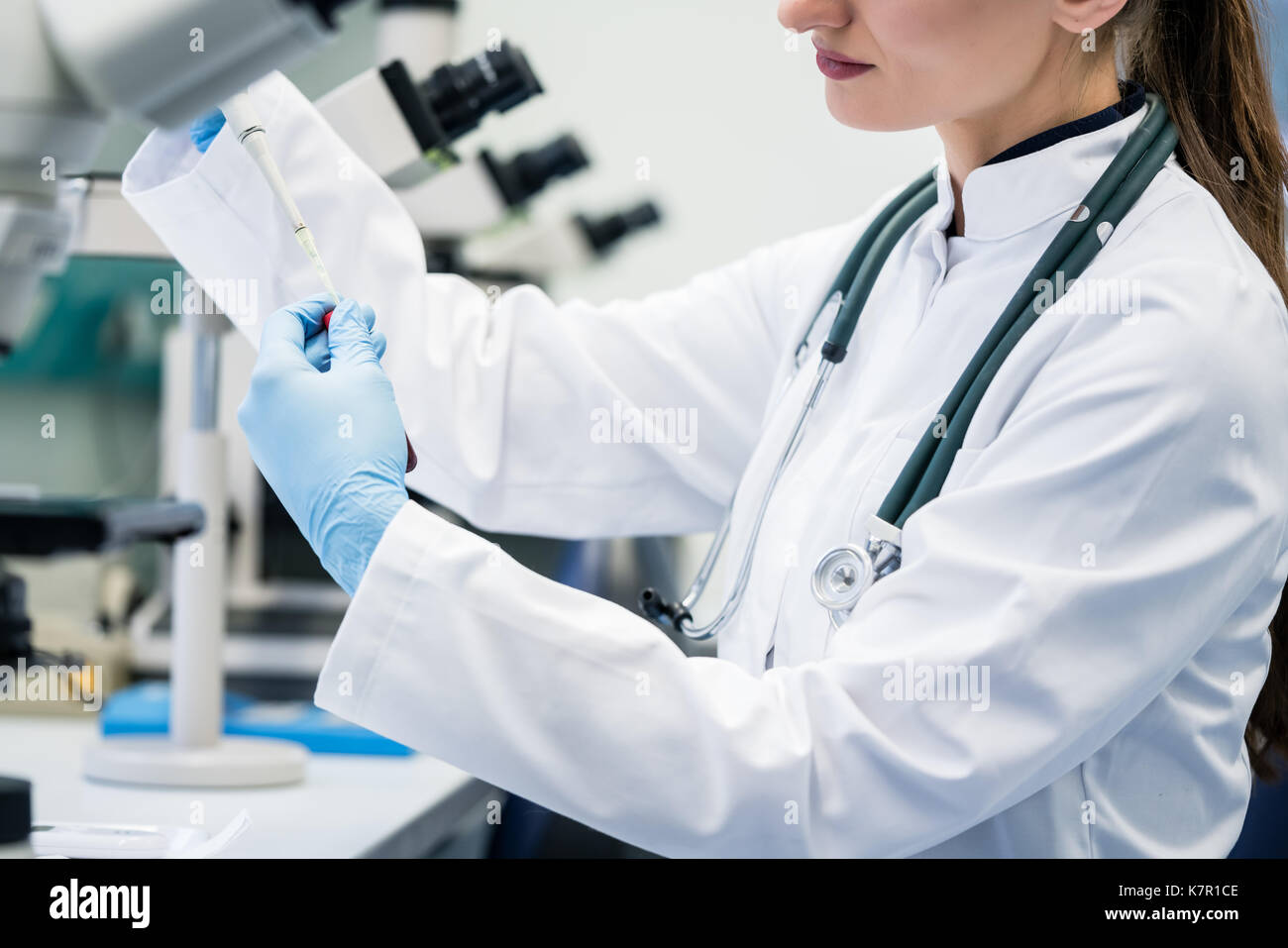 Doctor or lab assistant putting solution in blood test at the la Stock Photo