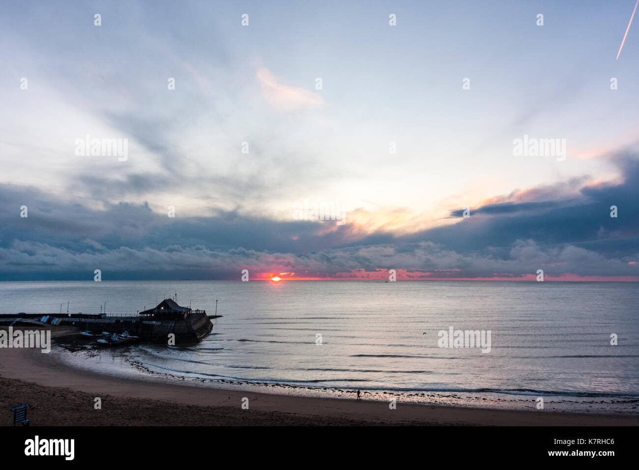 England, Broadstairs. Sunrise over the sea with Broadstairs harbour in