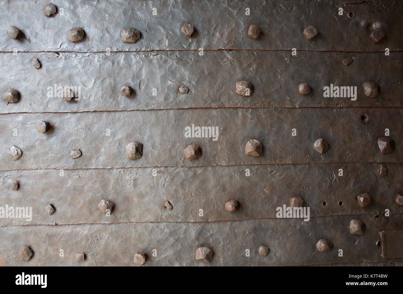 old rusty metal with rivets background or texture Stock Photo