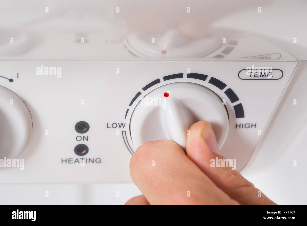Closeup Of Person Hands Turning The Knob Of Electric Boiler Stock