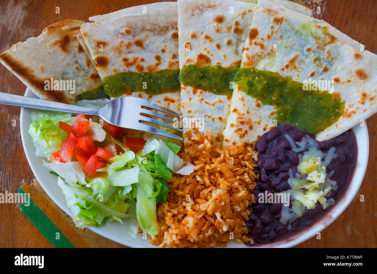 Quesadillas, with salsa verde, black beans, brown rice, cheese and salad Stock Photo