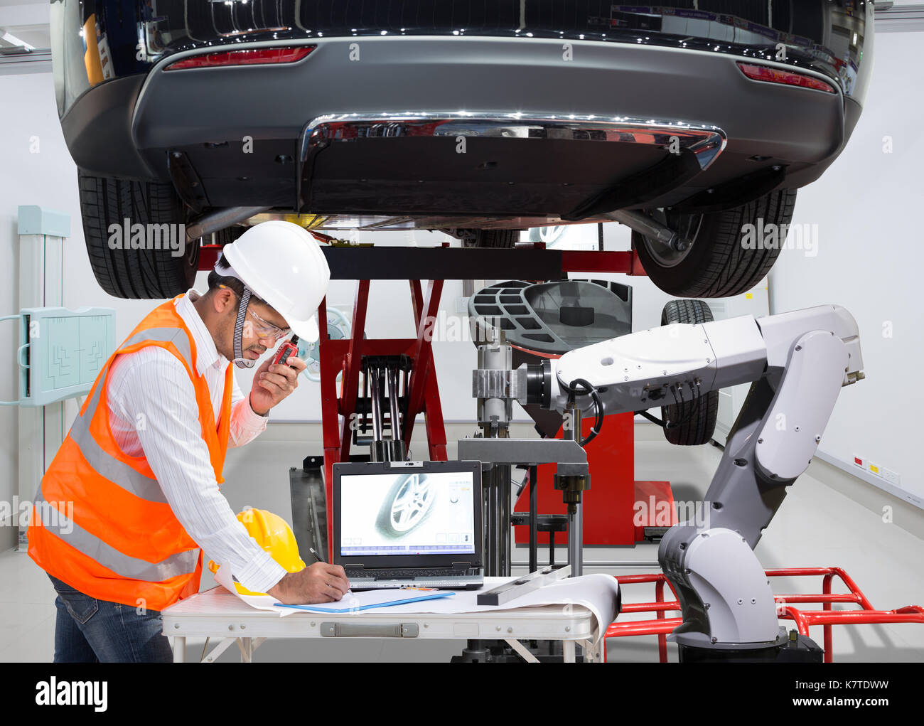 Mechanic with assistance robotic inspection wheel balancing of modern