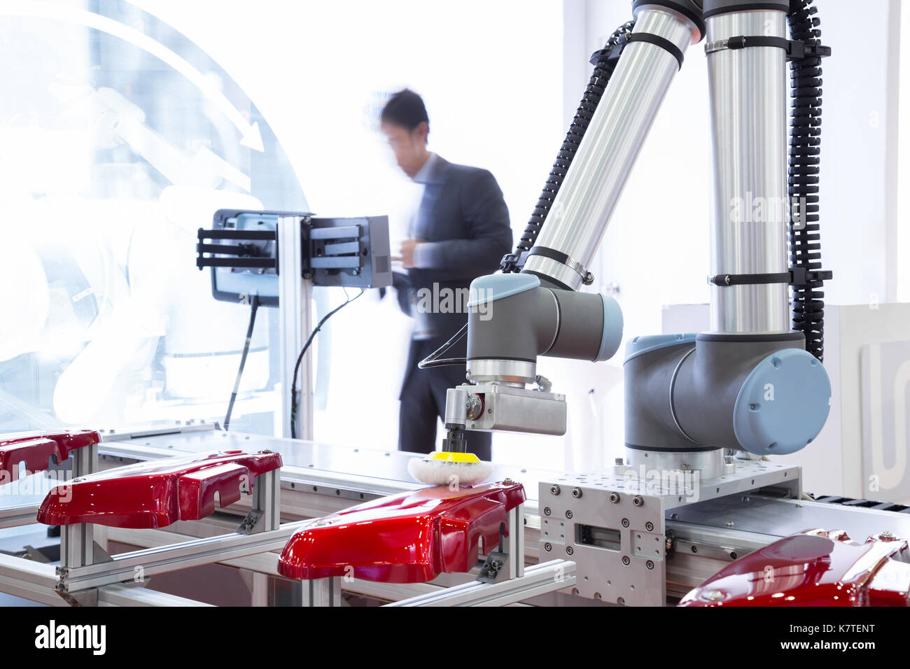 Automated robotic arm polishing automotive part in production line factory Stock Photo