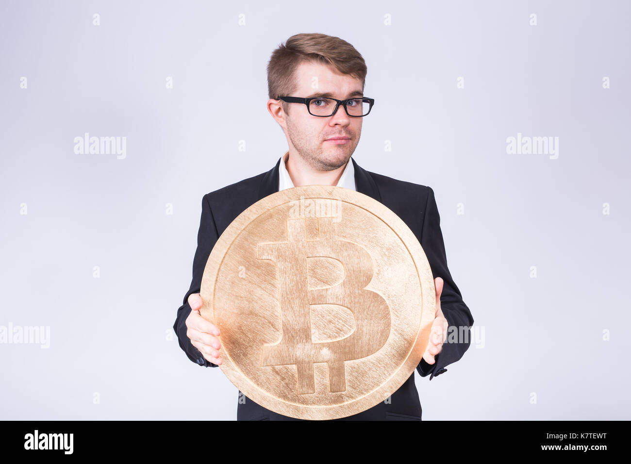 Business man holding big bitcoin in his hands. Cryptocurrency, people,  technology, money and future concept Stock Photo - Alamy