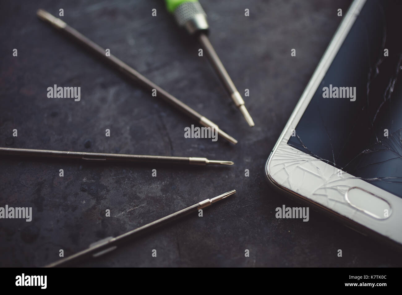 Smartphone with a broken screen and repair tools Stock Photo - Alamy