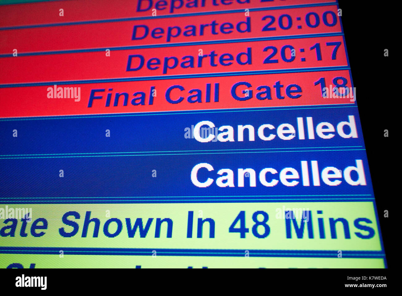 airport flight information screen showing departed, final call and cancelled flights Stock Photo
