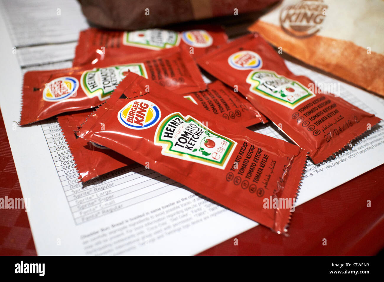 sachets of tomato sauce portions with a burger king meal Stock Photo