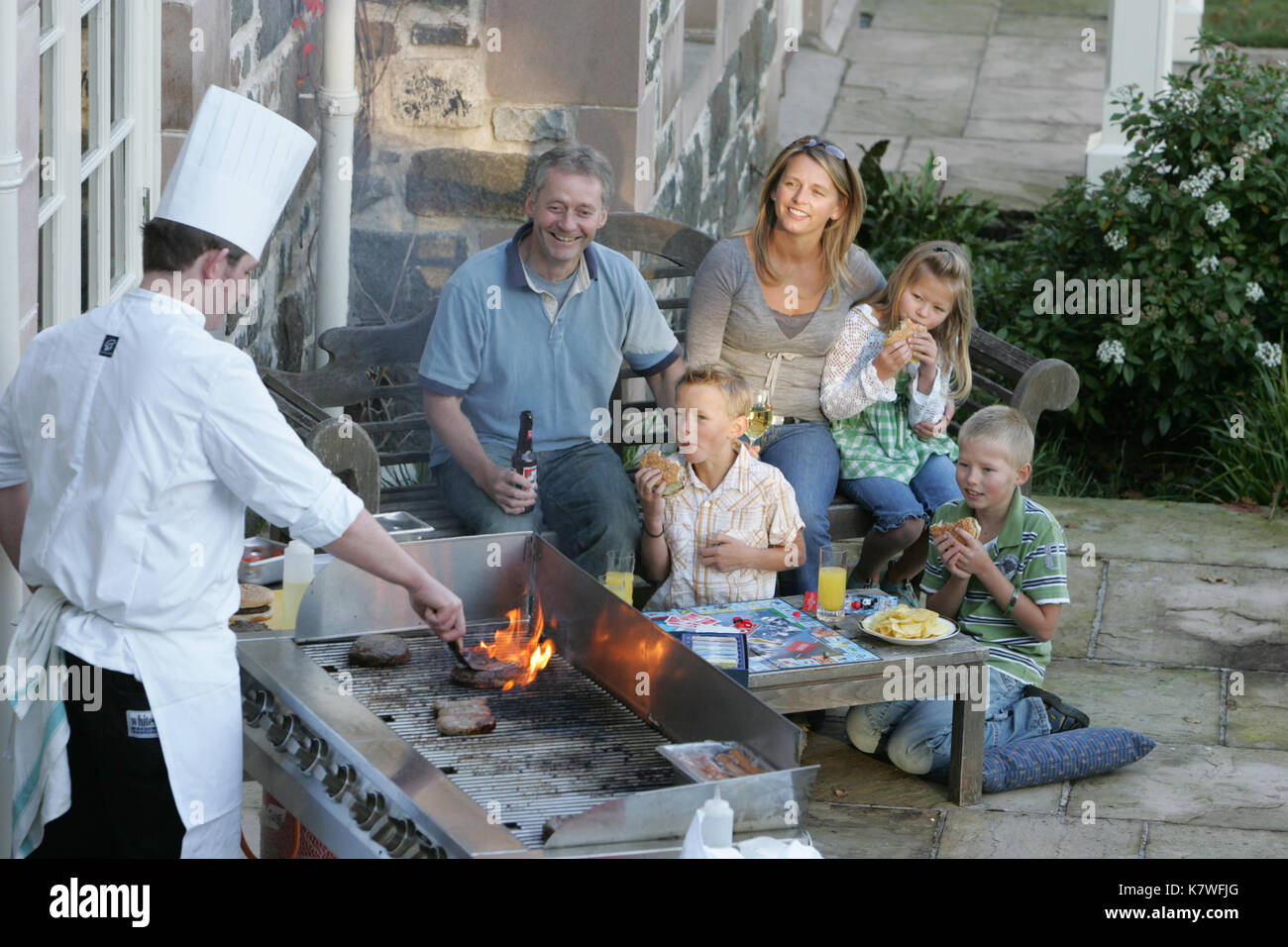 chef cooking barbecue for family Stock Photo