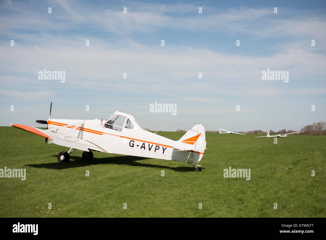 A tow plane with two gliders in a field. Storrington, West Sussex, United Kingdom Stock Photo