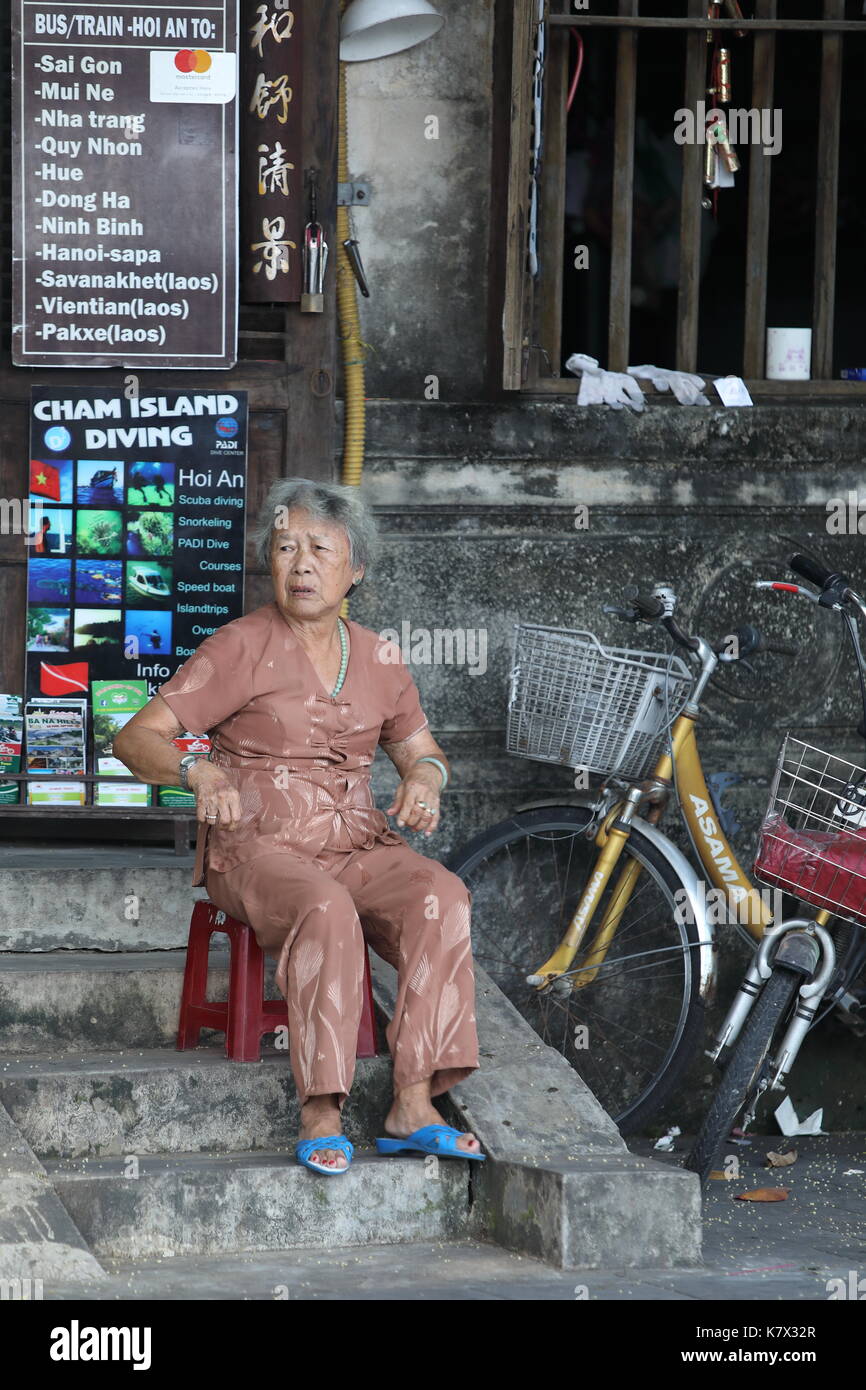 A single local Vietnamese in the streets of Hoi An old town, Vietnam Stock Photo