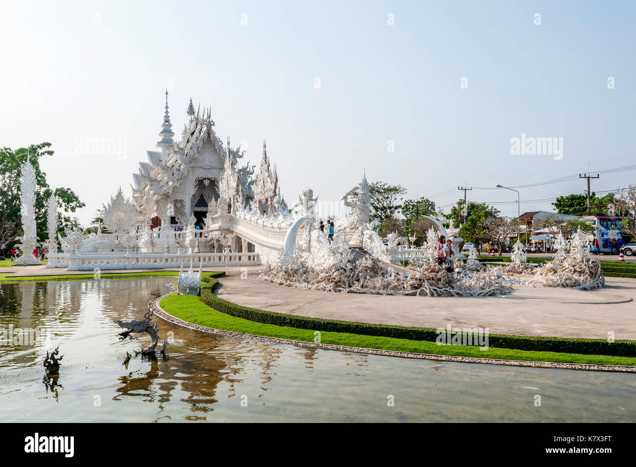 The bridge of the 'Cycle of Rebirth' leading to the Gate of Heaven and into the Ubosot at Wat Rong Khun (White Temple). Chiang Rai Province, Thailand Stock Photo