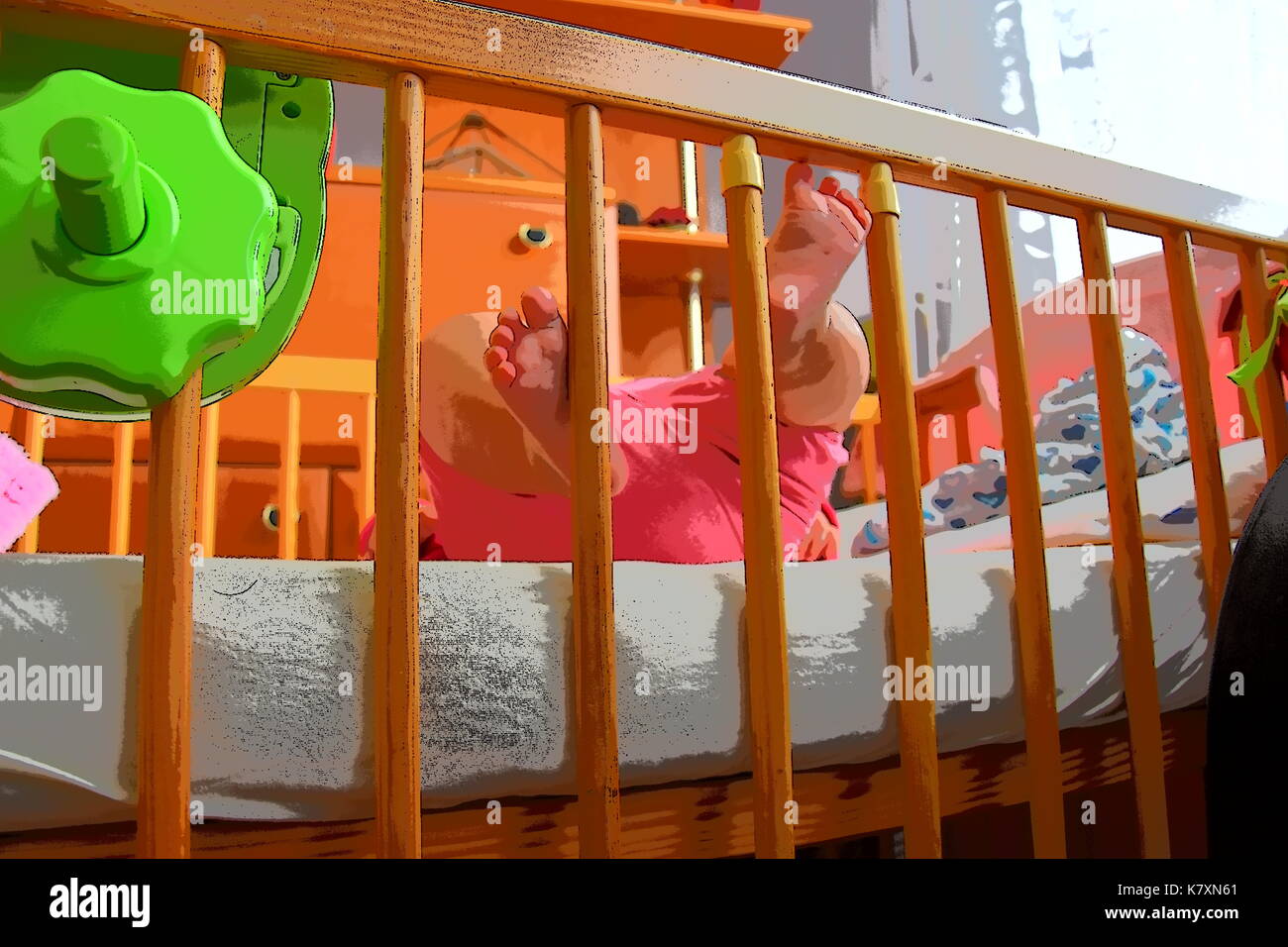 Baby, infant feet sticking out through the rails of a crib, cot