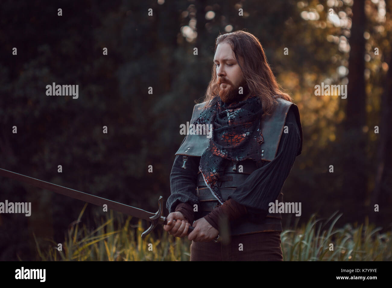 The bearded man knight. A guy in a medieval costume with a sword Stock ...