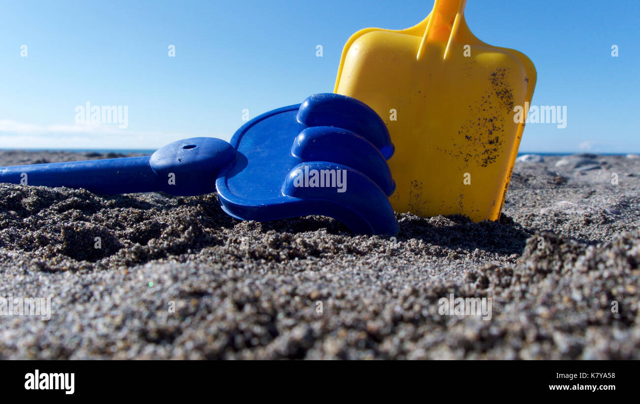 Bright coloured plastic toys at the beach Stock Photo