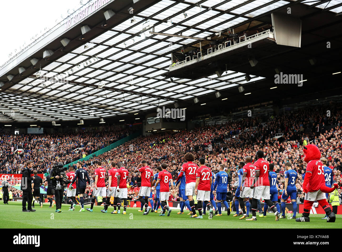 Manchester United and Everton players walk onto the pitch before the Premier League match at Old Trafford, Manchester. Stock Photo