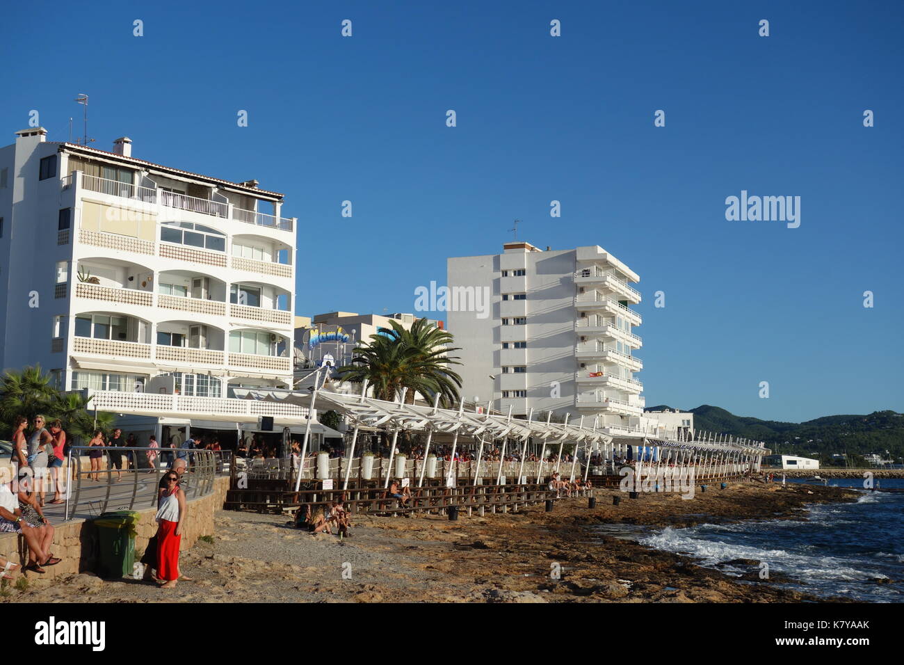 Tourists and local people waiting for sunset at Cafe Mambo, typical of the island of Ibiza. Sant Antonio de Portmany ,Balearic Islands, Spain Stock Photo