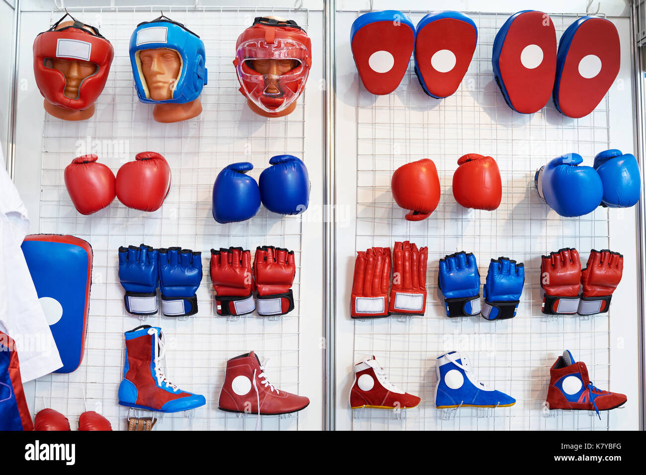 Boxing gloves, helmets and shoes for martial arts in a sports shop Stock  Photo - Alamy