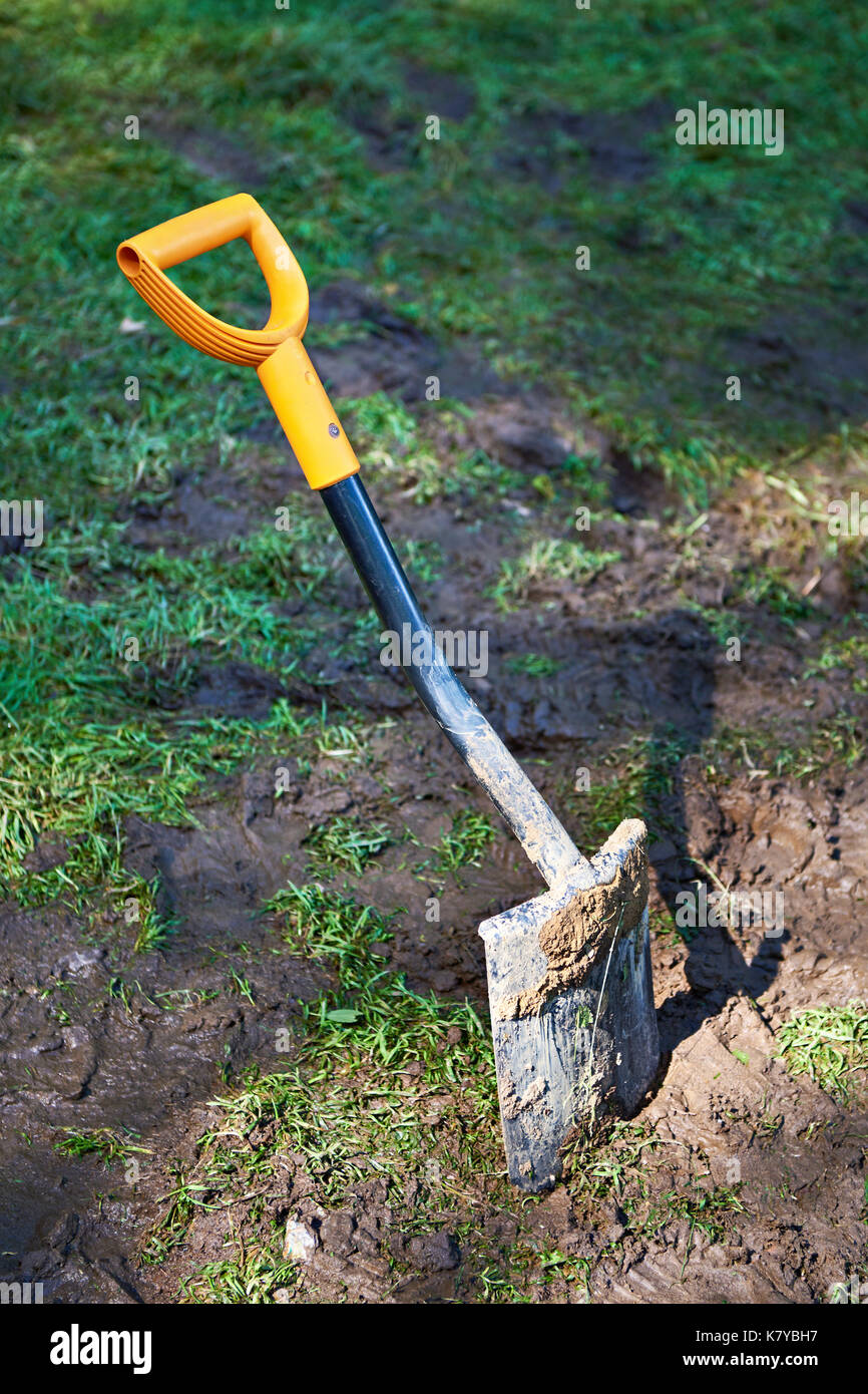Dirty camp hiking shovel in ground Stock Photo Alamy