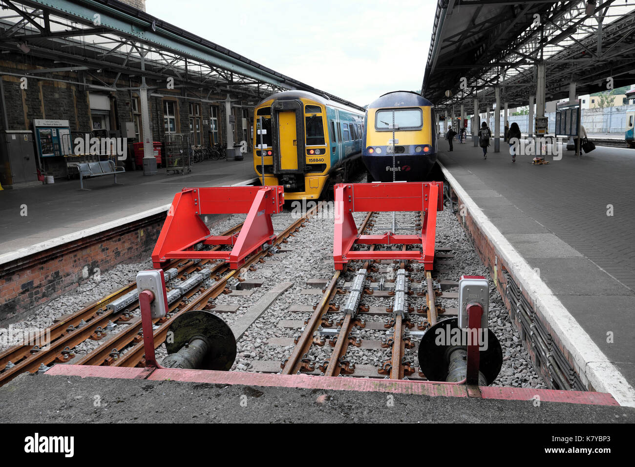 Trains and new red friction buffers on the rail tracks at Swansea train railway station in South Wales UK  KATHY DEWITT Stock Photo