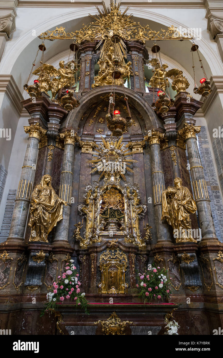 Ornate and golden altar at the Church of Our Lady Victorious (Infant Jesus of Prague) in Prague, Czech Republic, viewed from the front. Stock Photo