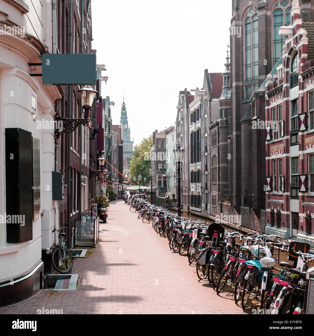 Street with typical Dutch houses and bicycles in Amsterdam Stock Photo ...