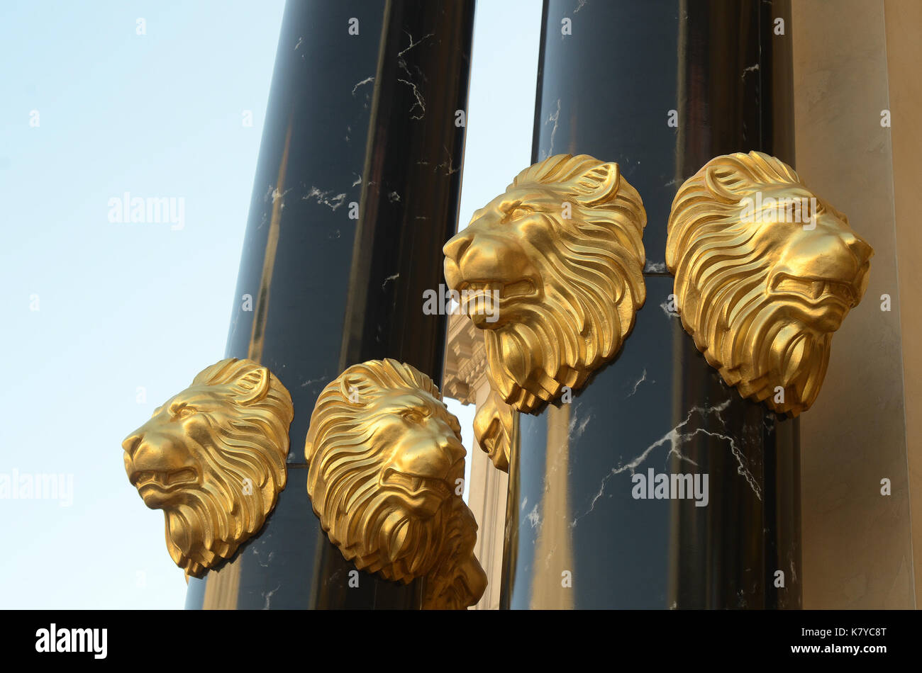 gold lion head sculpture black marble pillars Stock Photo Alamy